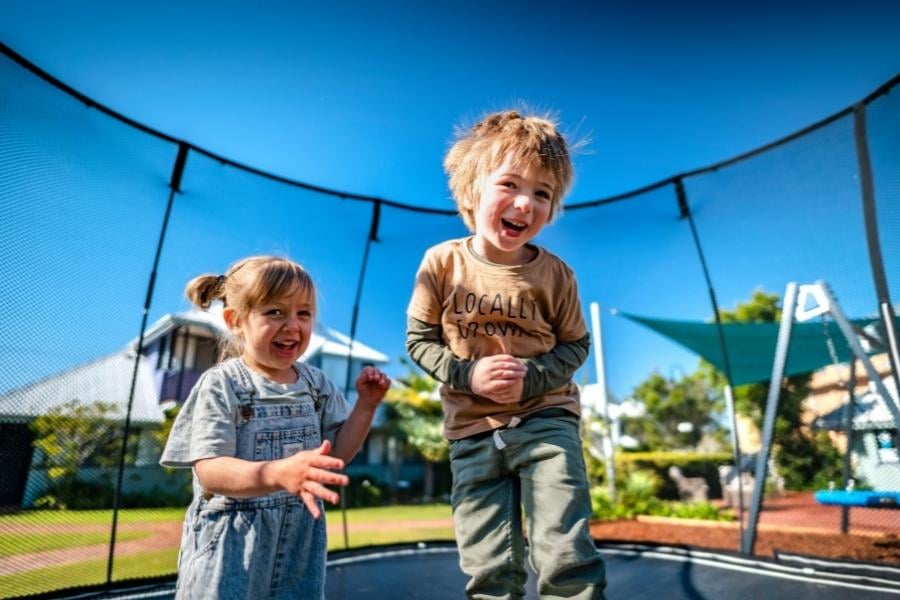 Children jumping on the trampoline at Riverside Holiday Resorts 900 × 600