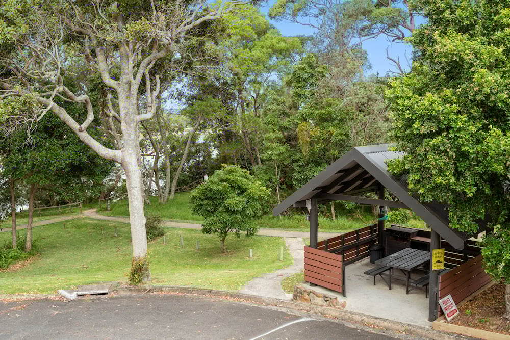 Haven BBQ and picnic seating next to path to the inlet