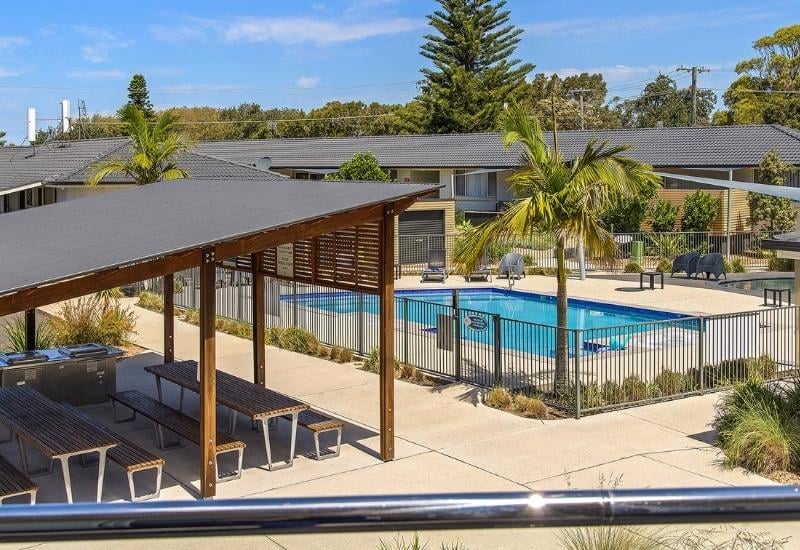 Seaside Holiday Resort Fingal Bay BBQ area with picnic tables and pool